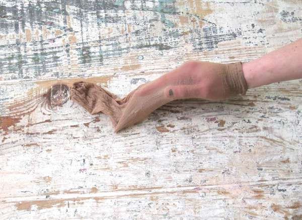 اليد في جوارب طويلة على لوح خشبي