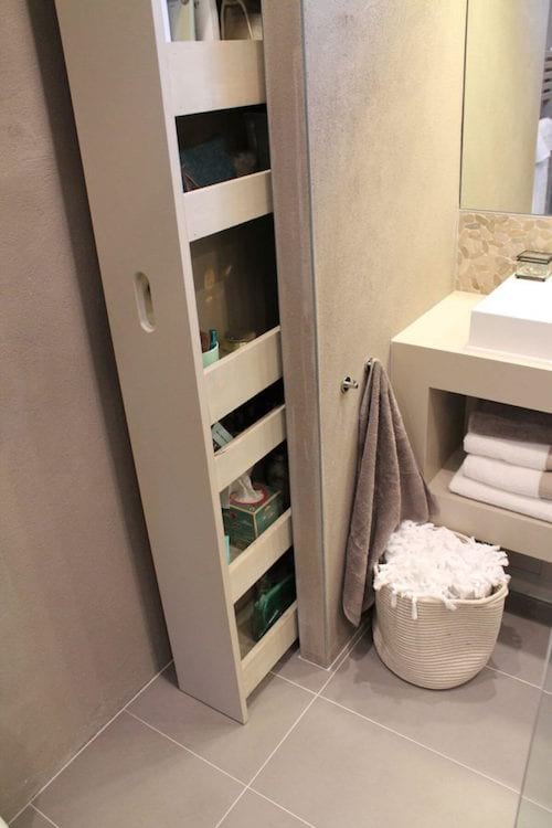 un estante deslizante en el baño para ahorrar espacio
