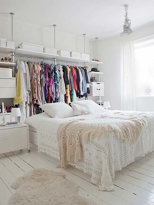 Dressing room behind white double bed