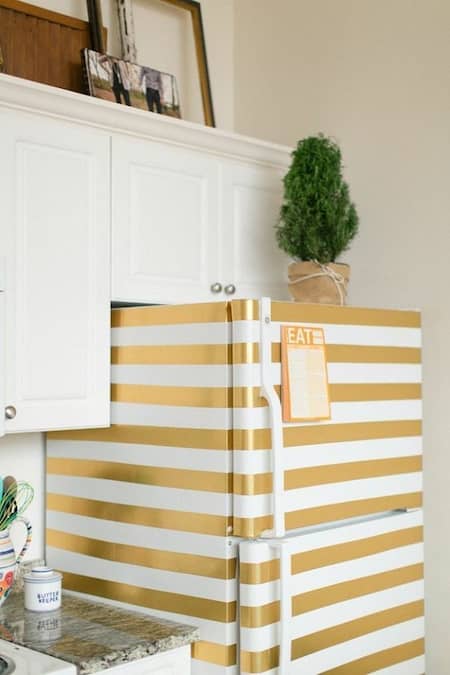 masking tape is used to decorate an old fridge