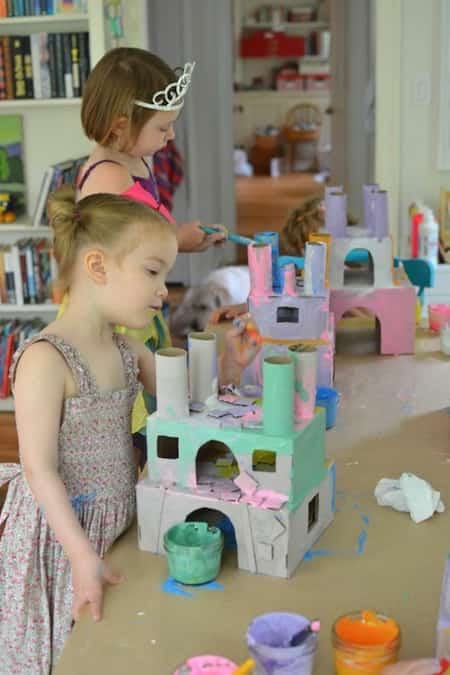 چھوٹی لڑکیاں خالی ٹوائلٹ پیپر رولز سے قلعہ بناتی ہیں۔