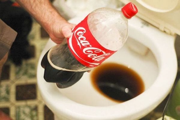 ampolla de coca-cola abocada al vàter per descalcificar