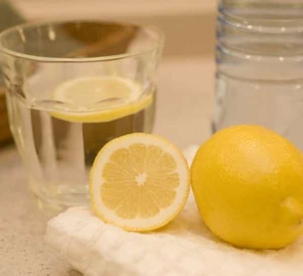 كوب من الماء مع شرائح الليمون لتخفيف السعال